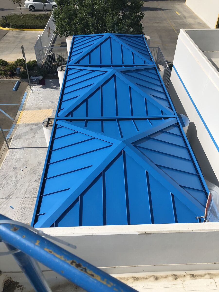 Blue geometric decorative panels on a commercial building