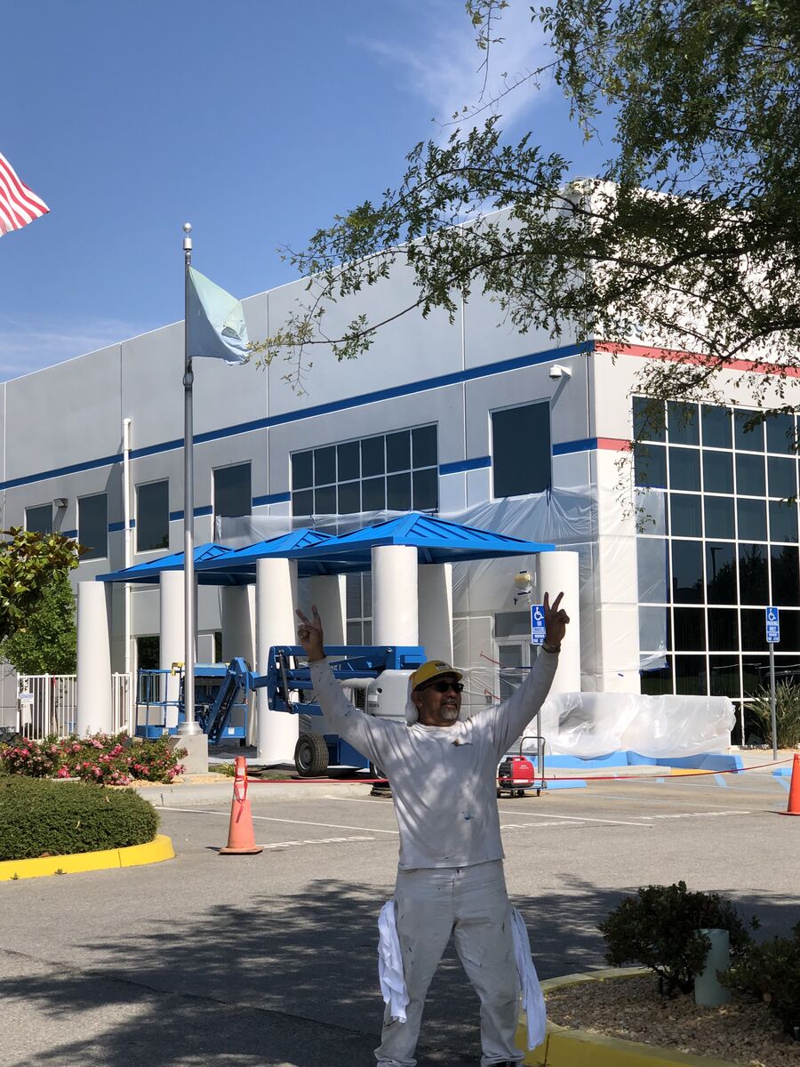 Commercial building exterior with freshly painted white and blue finish