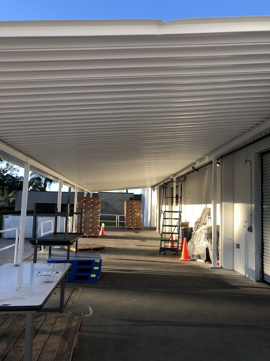 Industrial building with freshly painted white corrugated metal siding